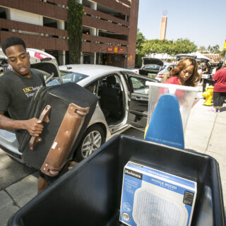 Lisa Tanker (check) moves some things while her son <a href=