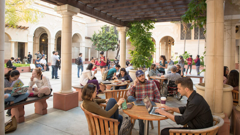 Students meeting at an outdoor courtyard near the USC School of Cinematic Arts.