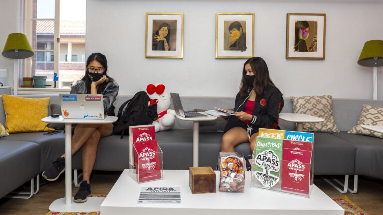Two students studying in the USC Asian Pacific American Student Services lounge.