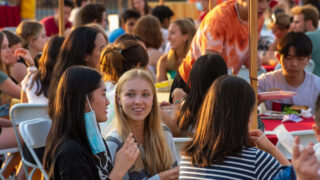 Students talking with each other at BBQ dinner