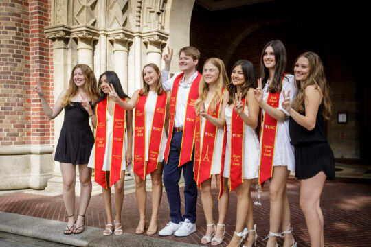 Eight USC students pose in front of Bovard
