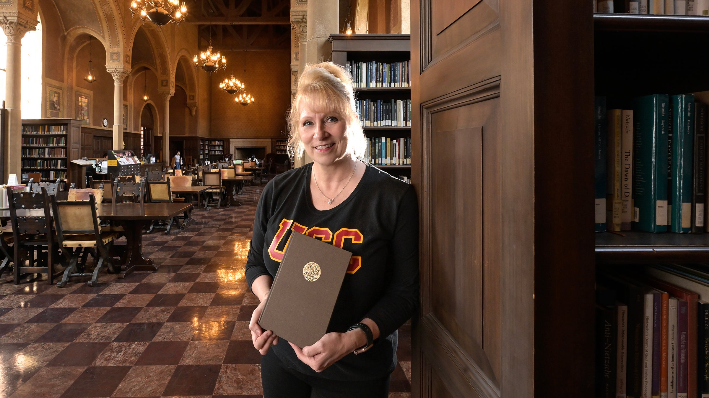 Melissa L. Miller head, Hoose library of philosophy with her favorite book Dr. Flewlling &The Hoose Library “Life and Letters of a Man and an Institution” by Wallace Nethery, Oct. 7, 2024.(USC Photo/Gus Ruelas)