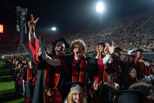 USC graduates exclaim in excitement at the camera