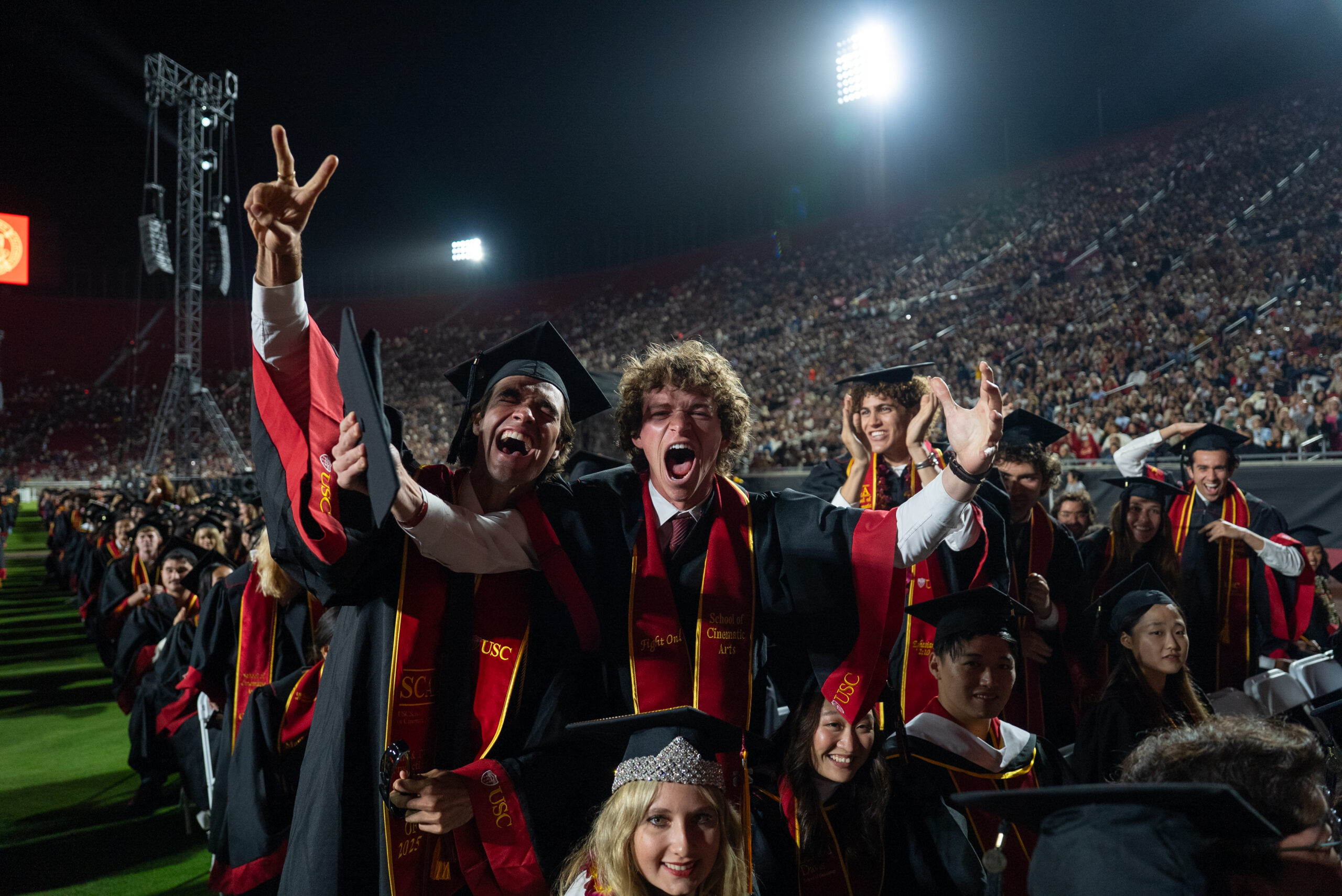 USC graduates exclaim in excitement at the camera