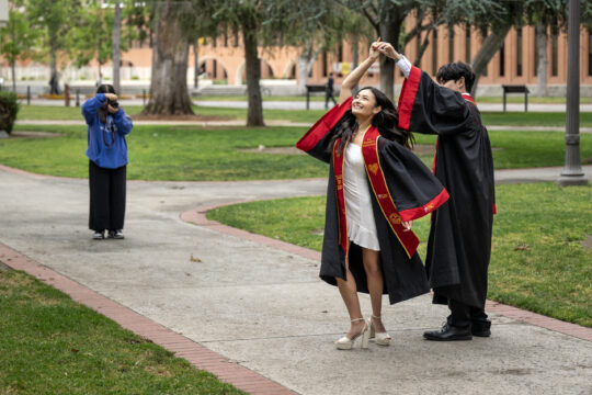 USC freshman Zoe Zane takes pictures of graduating sister Jadynne Zane with Ryan Higa
