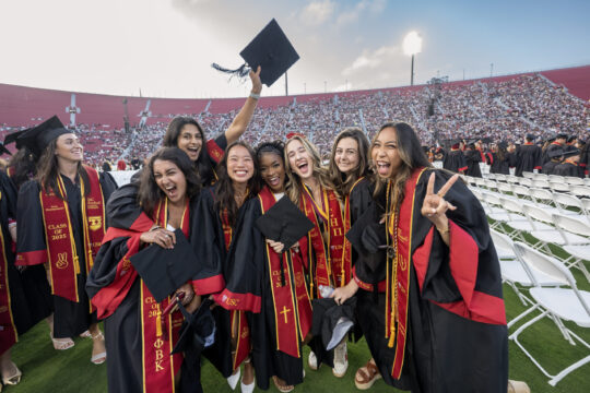 USC graduates hug and celebrate