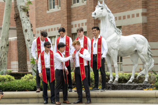 USC French study students pose for photograph in preparation for their graduation