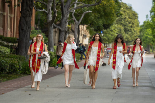 Graduates and roommates make their way across campus as the pose for pictures UPC landmarks