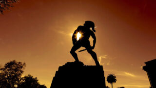 Tommy Trojan with sun in background
